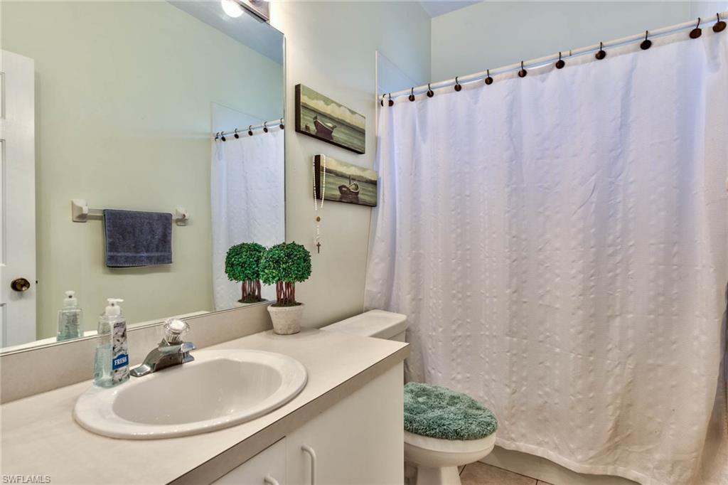 18258 Fuchsia Road Fort Myers, FL 33967 - Photo 16 of 22 a bathroom with a sink and a mirror