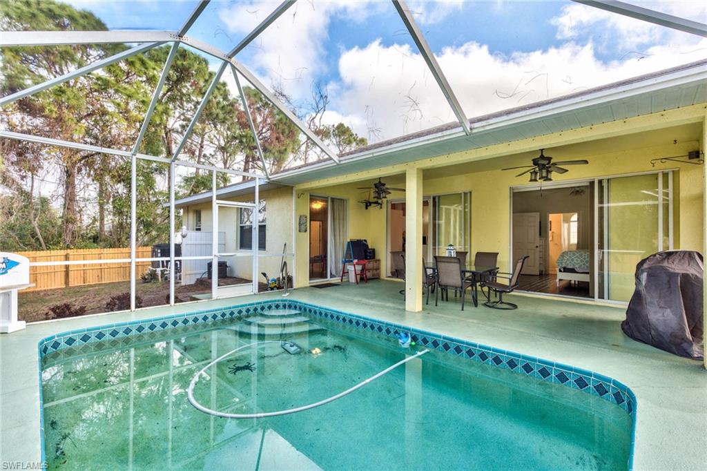 18258 Fuchsia Road Fort Myers, FL 33967 - Photo 19 of 22 a backyard of a house with table and chairs