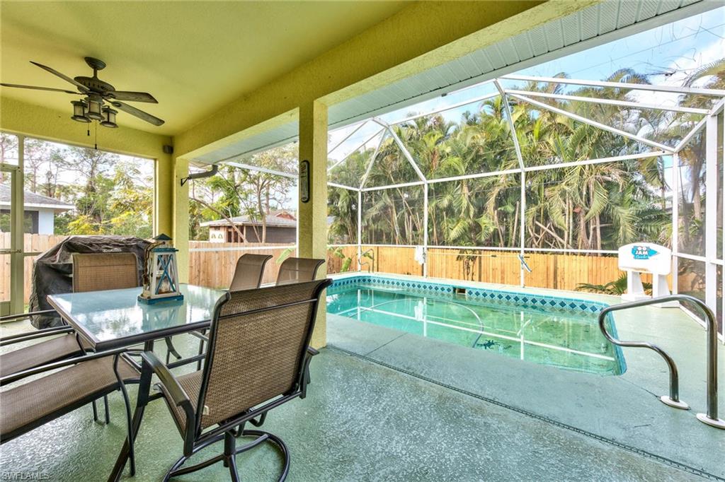 18258 Fuchsia Road Fort Myers, FL 33967 - Photo 21 of 22 a living room with a floor to ceiling windows and a table