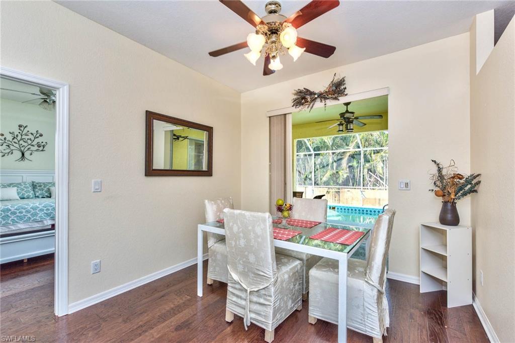 18258 Fuchsia Road Fort Myers, FL 33967 - Photo 6 of 22 a dining room with furniture a window and wooden floor