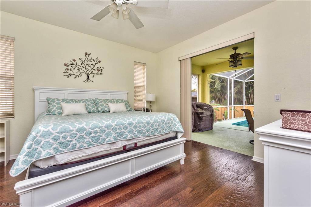 18258 Fuchsia Road Fort Myers, FL 33967 - Photo 7 of 22 a bedroom with a bed and a chandelier
