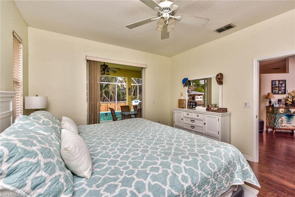 18258 Fuchsia Road Fort Myers, FL 33967 - Photo 8 of 22 a bedroom with a large bed and a chandelier