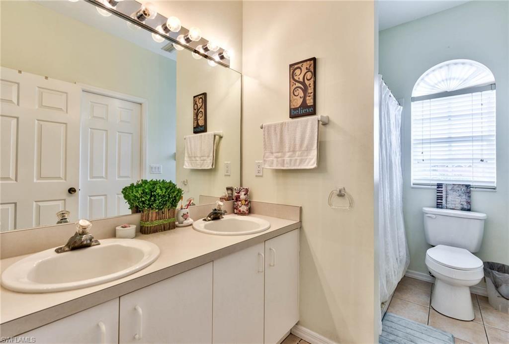 18258 Fuchsia Road Fort Myers, FL 33967 - Photo 9 of 22 a bathroom with a toilet sink and mirror