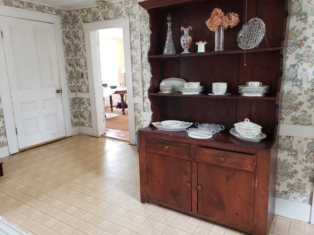 6 Northeast Fitzwilliam Road Royalston, MA 01368 - Photo 12 of 21 a kitchen with a wooden floor and a table