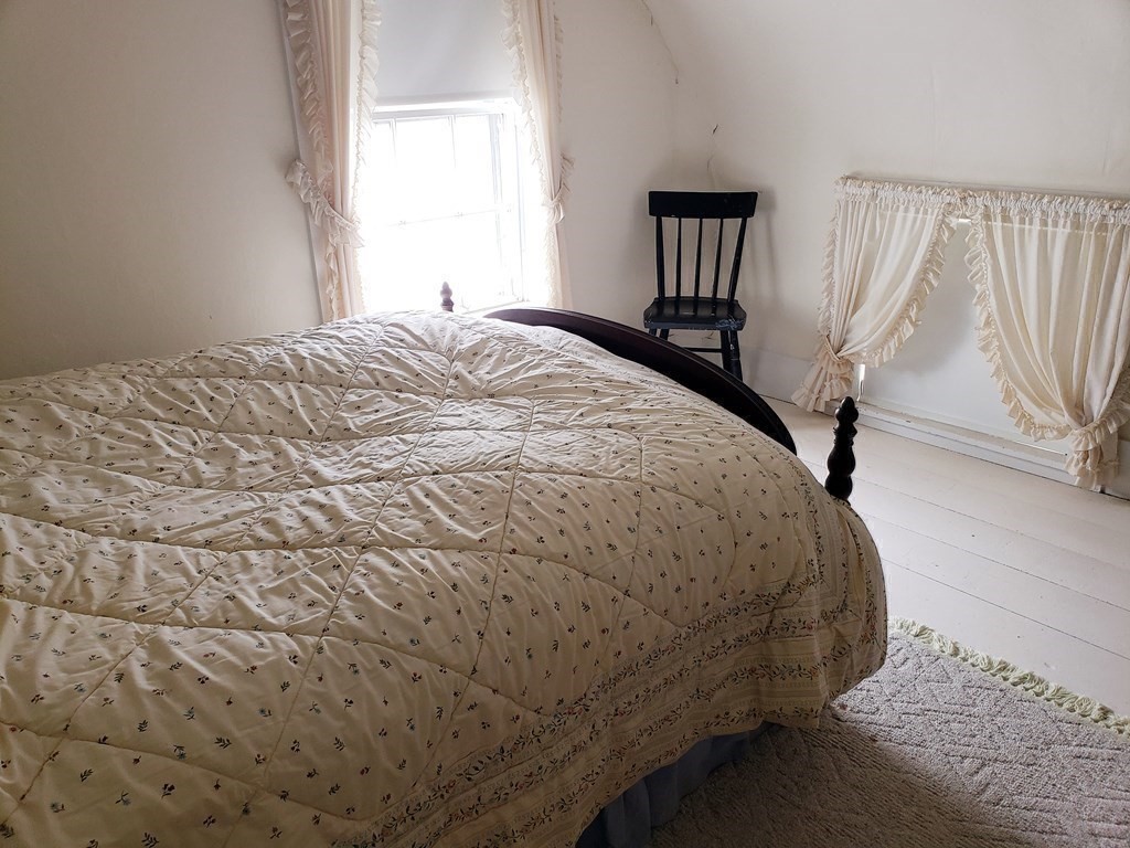 6 Northeast Fitzwilliam Road Royalston, MA 01368 - Photo 14 of 21 a bed sitting in a bedroom next to a window