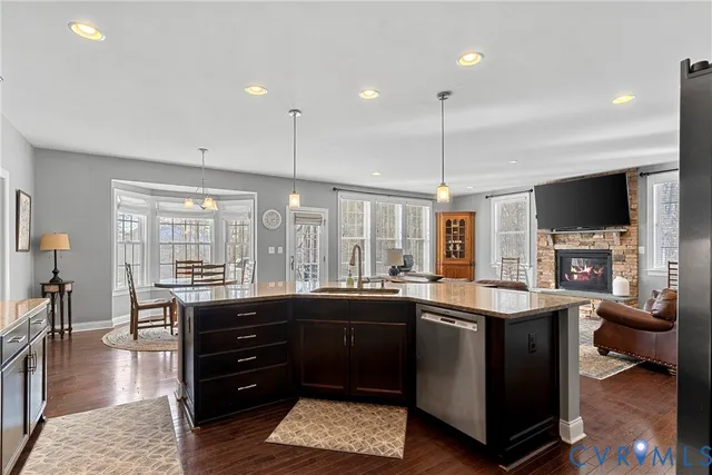 a kitchen with stainless steel appliances granite countertop a sink and a stove top oven