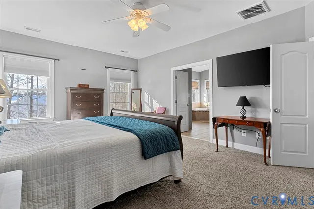 a view of an empty room with staircase and a window