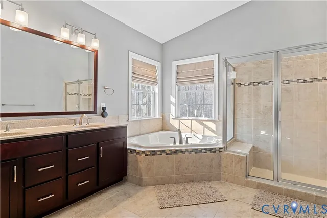 a bathroom with a double vanity sink toilet and a mirror