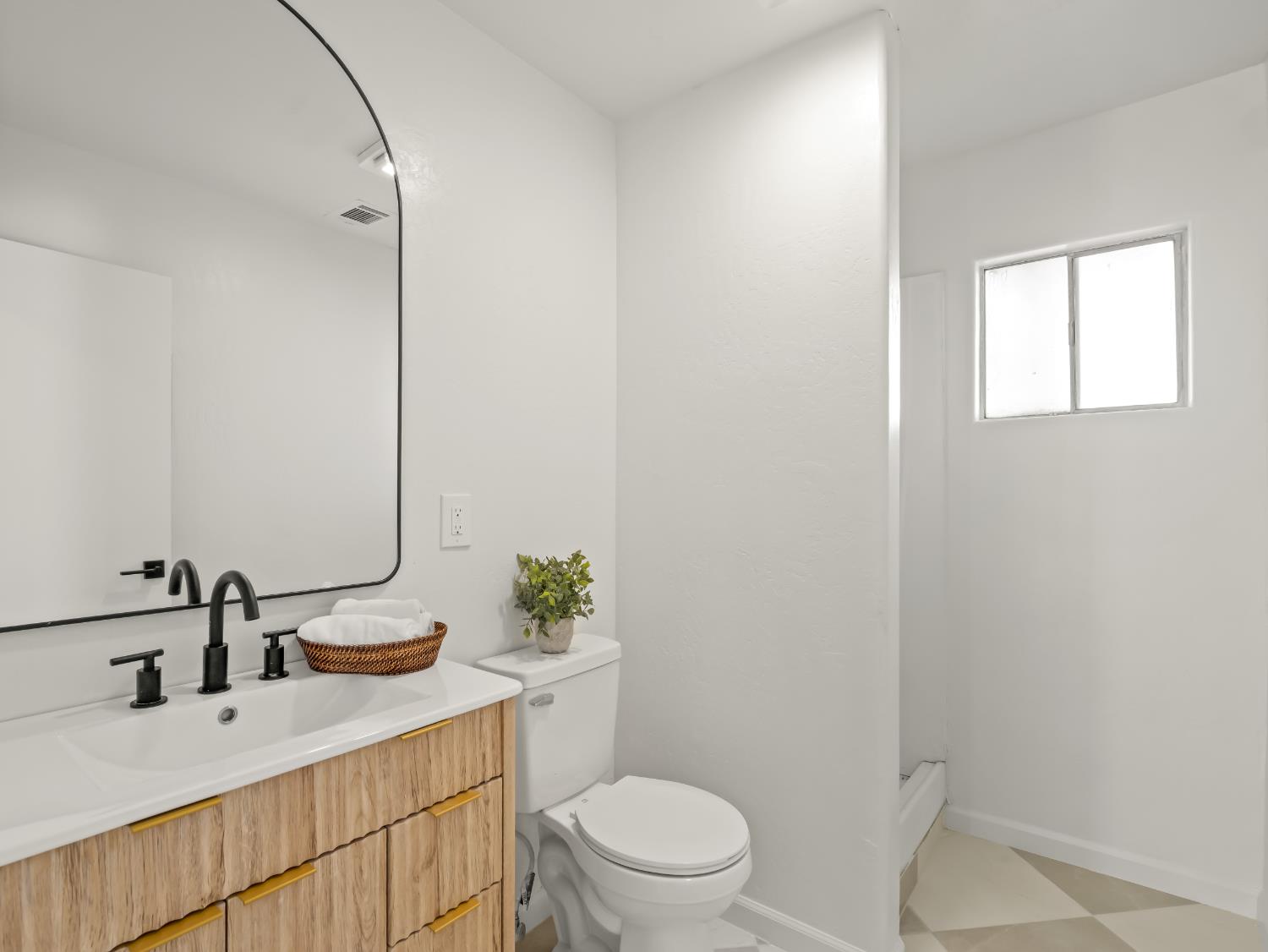 425 West Elm Street Hanford, CA 93230 - Photo 15 of 18 a bathroom with a double vanity sink toilet and a mirror