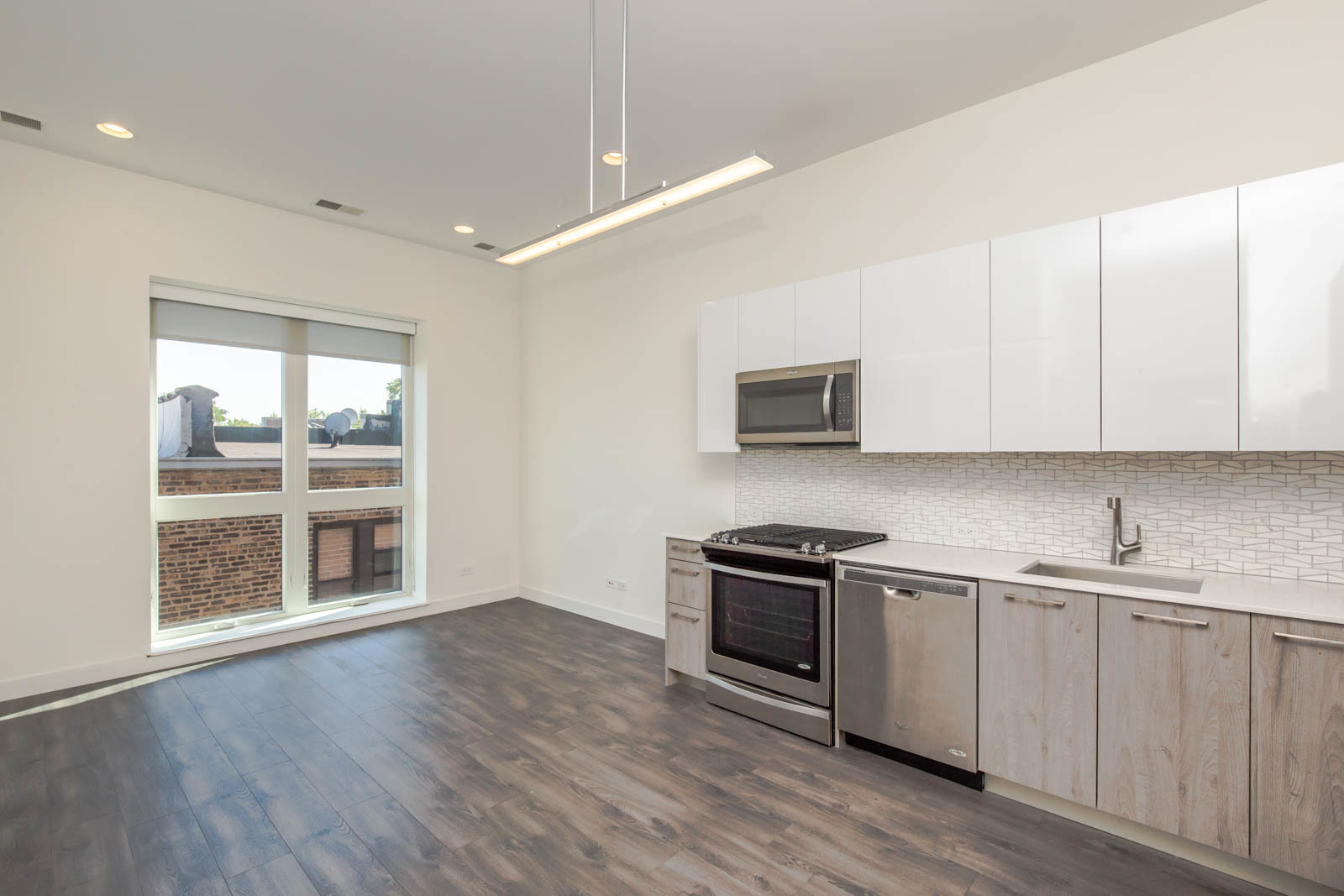 Undisclosed Address Chicago, IL 60641 - Photo 3 of 9 a kitchen with stainless steel appliances granite countertop a stove a sink and a microwave