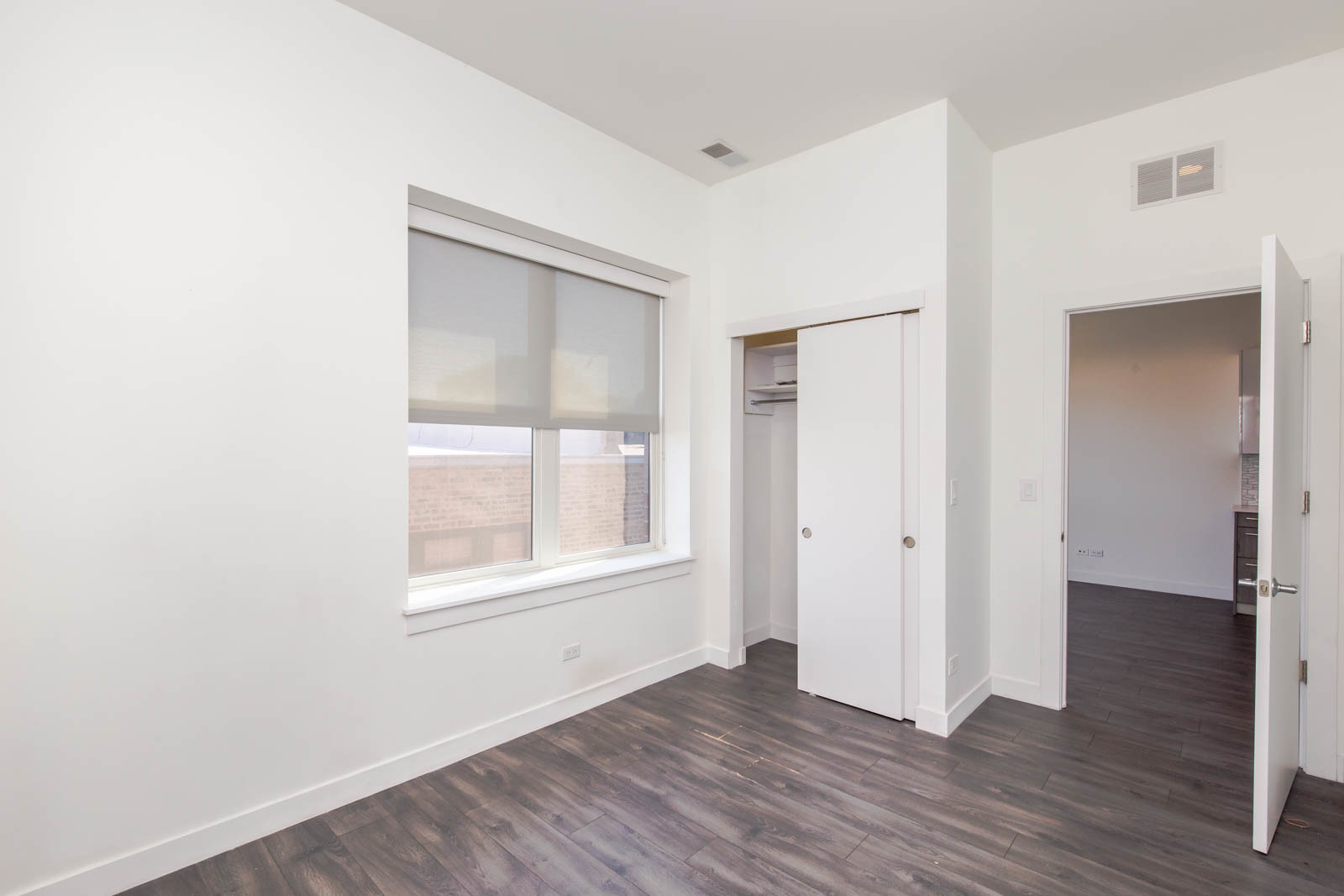 Undisclosed Address Chicago, IL 60641 - Photo 6 of 9 an empty room with wooden floor and windows