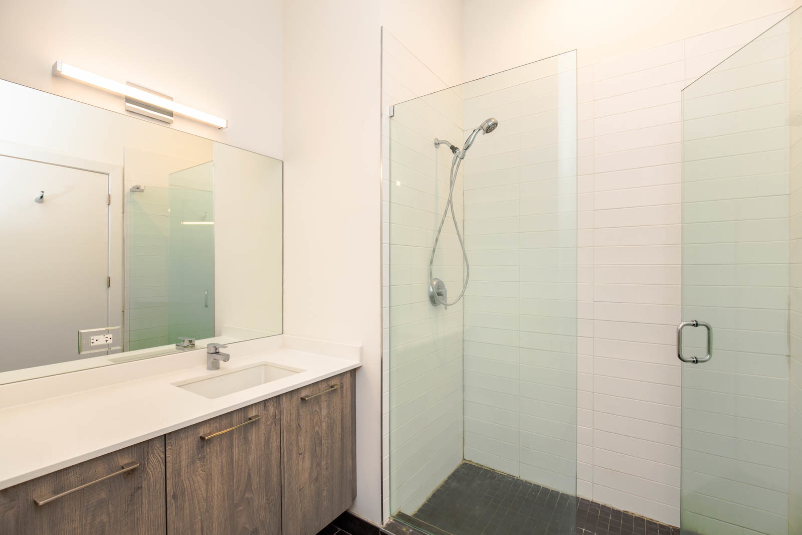 Undisclosed Address Chicago, IL 60641 - Photo 8 of 9 a bathroom with a double vanity sink and mirror