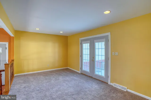 a bathroom with a toilet a sink a mirror and a window