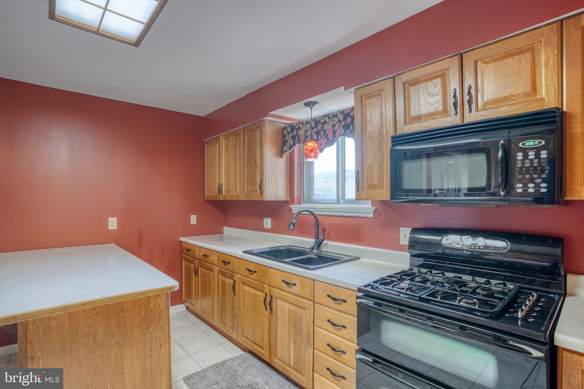 2158 South State Street Dover, DE 19901 - Photo 24 of 51 a kitchen with stainless steel appliances granite countertop a stove a sink and a microwave