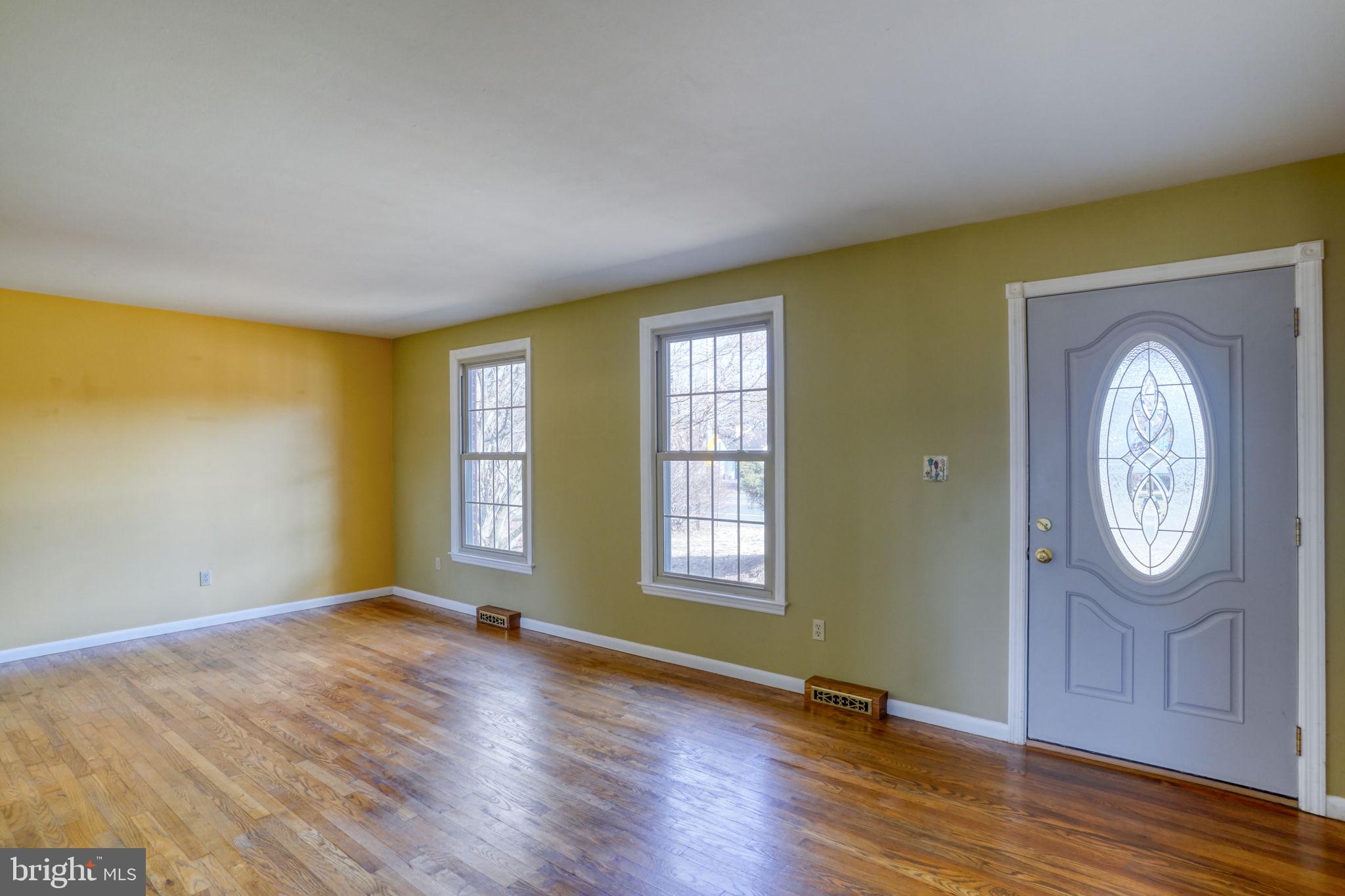 2158 South State Street Dover, DE 19901 - Photo 27 of 51 an empty room with wooden floor mirror and windows