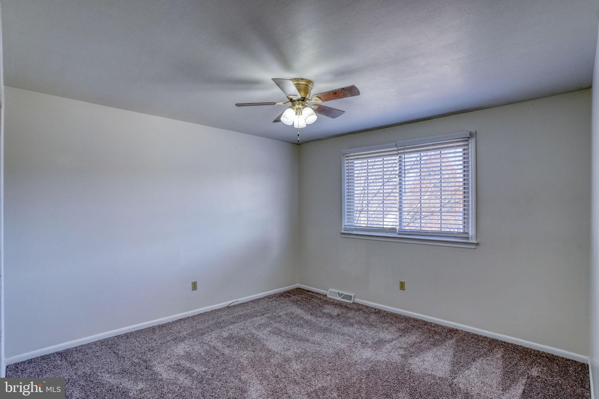 2158 South State Street Dover, DE 19901 - Photo 32 of 51 an empty room with a window and a ceiling fan