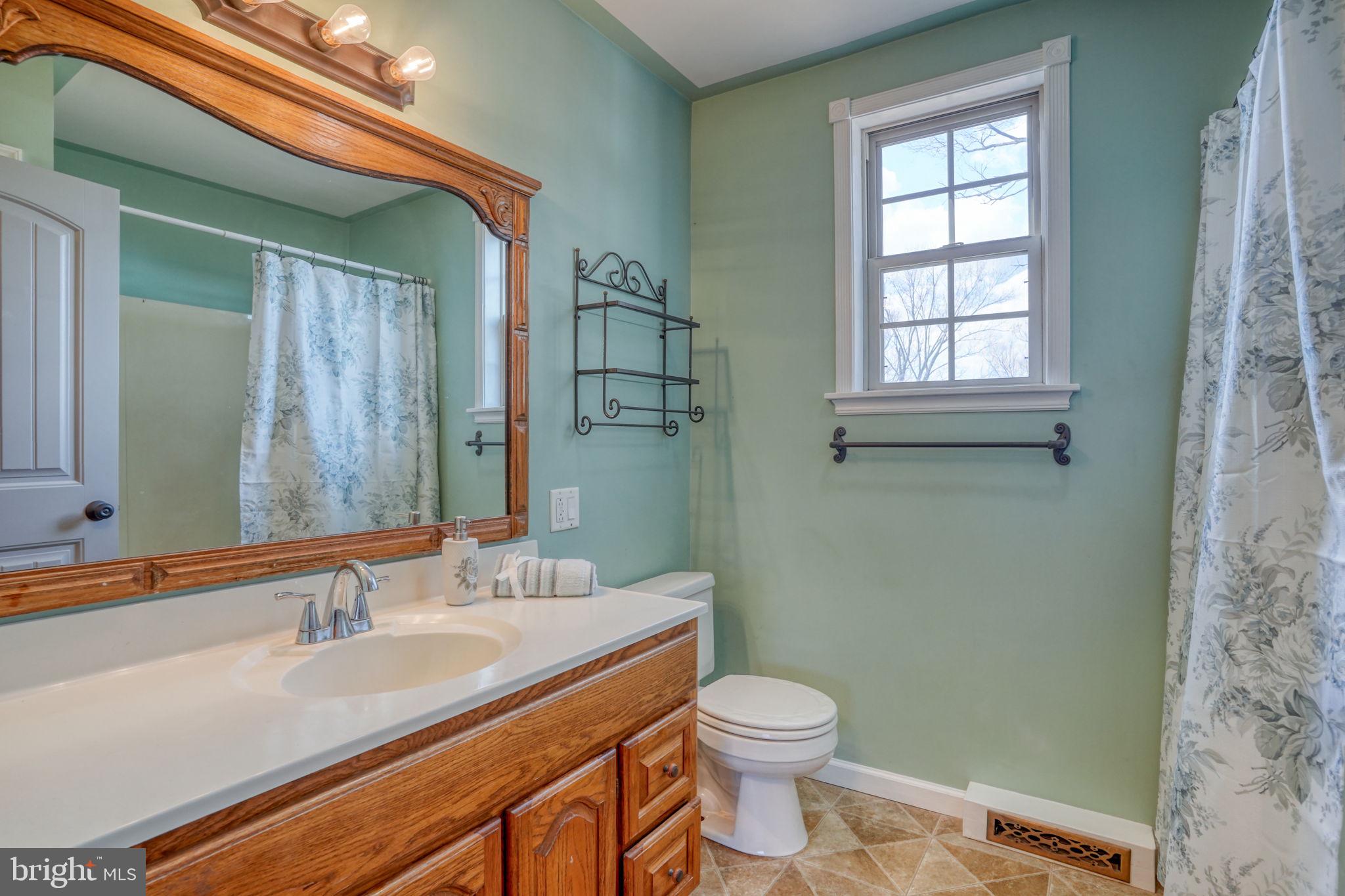 2158 South State Street Dover, DE 19901 - Photo 36 of 51 a bathroom with a granite countertop sink a toilet and a mirror