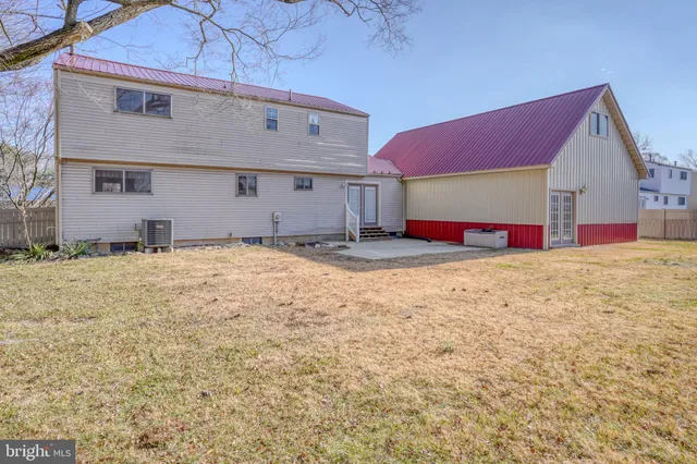 an aerial view of residential houses with outdoor space and parking