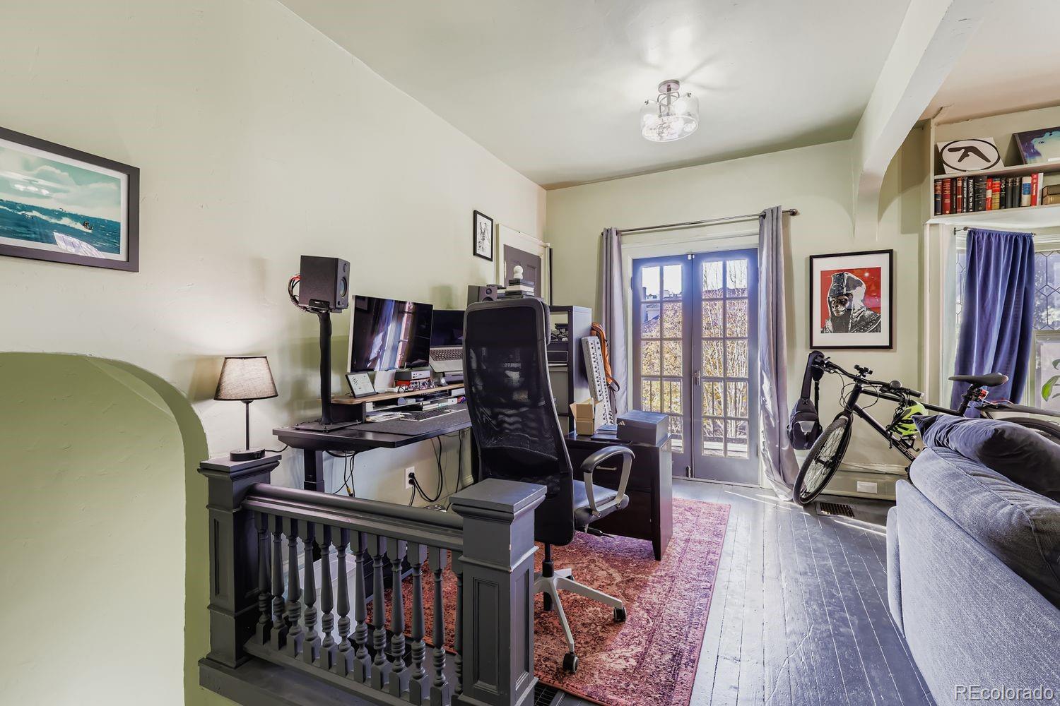 854 North Clarkson Street Denver, CO 80218 - Photo 11 of 34 a living room with furniture a couch and a flat screen tv