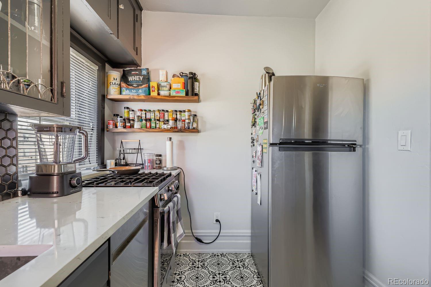 854 North Clarkson Street Denver, CO 80218 - Photo 12 of 34 a kitchen with stainless steel appliances granite countertop a sink stove and refrigerator