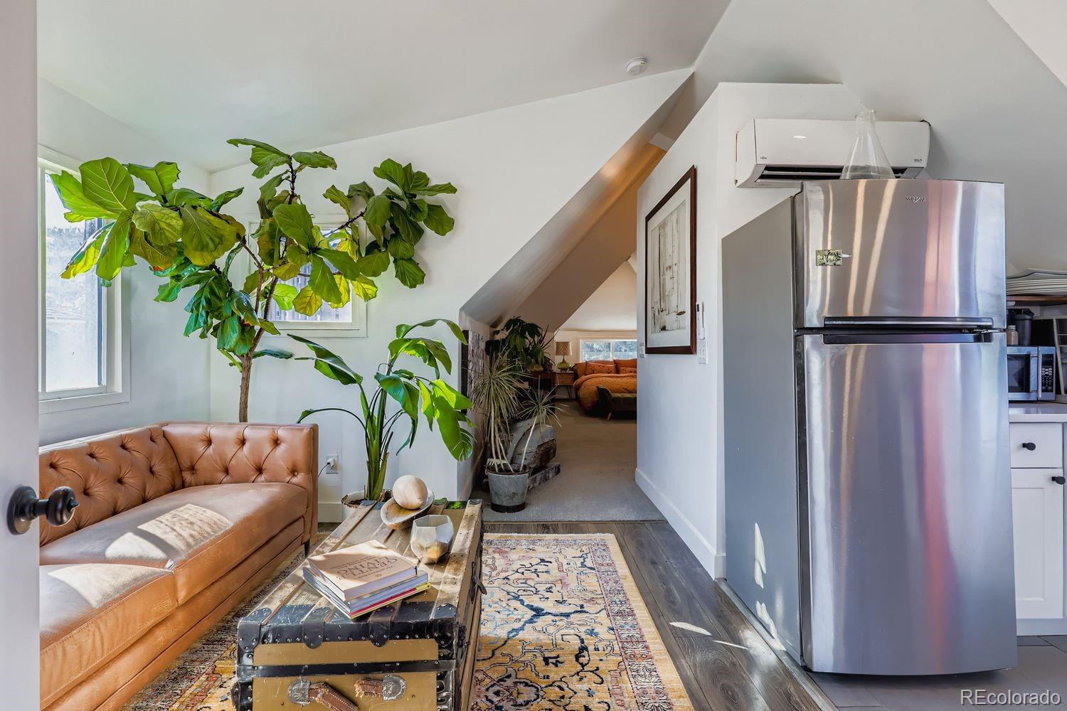 854 North Clarkson Street Denver, CO 80218 - Photo 17 of 34 a living room with stainless steel appliances furniture wooden floor and a rug