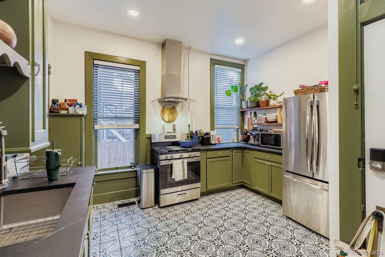 854 North Clarkson Street Denver, CO 80218 - Photo 22 of 34 a kitchen with a refrigerator and a sink