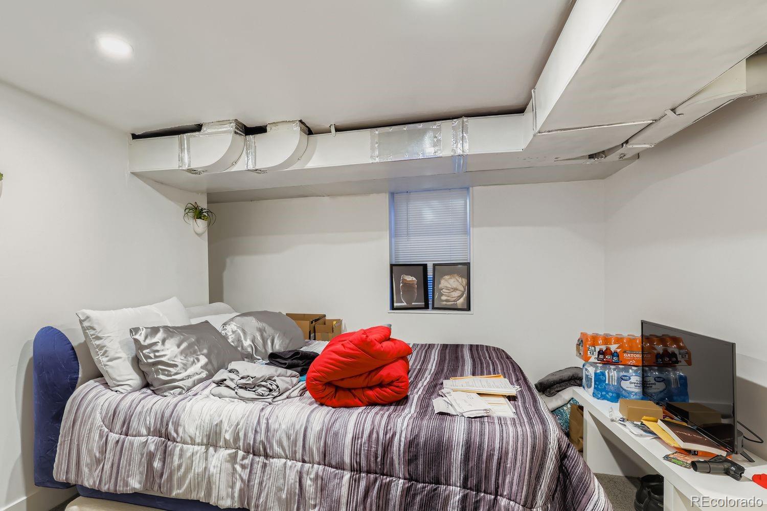 854 North Clarkson Street Denver, CO 80218 - Photo 25 of 34 a bedroom with a bed and a couch