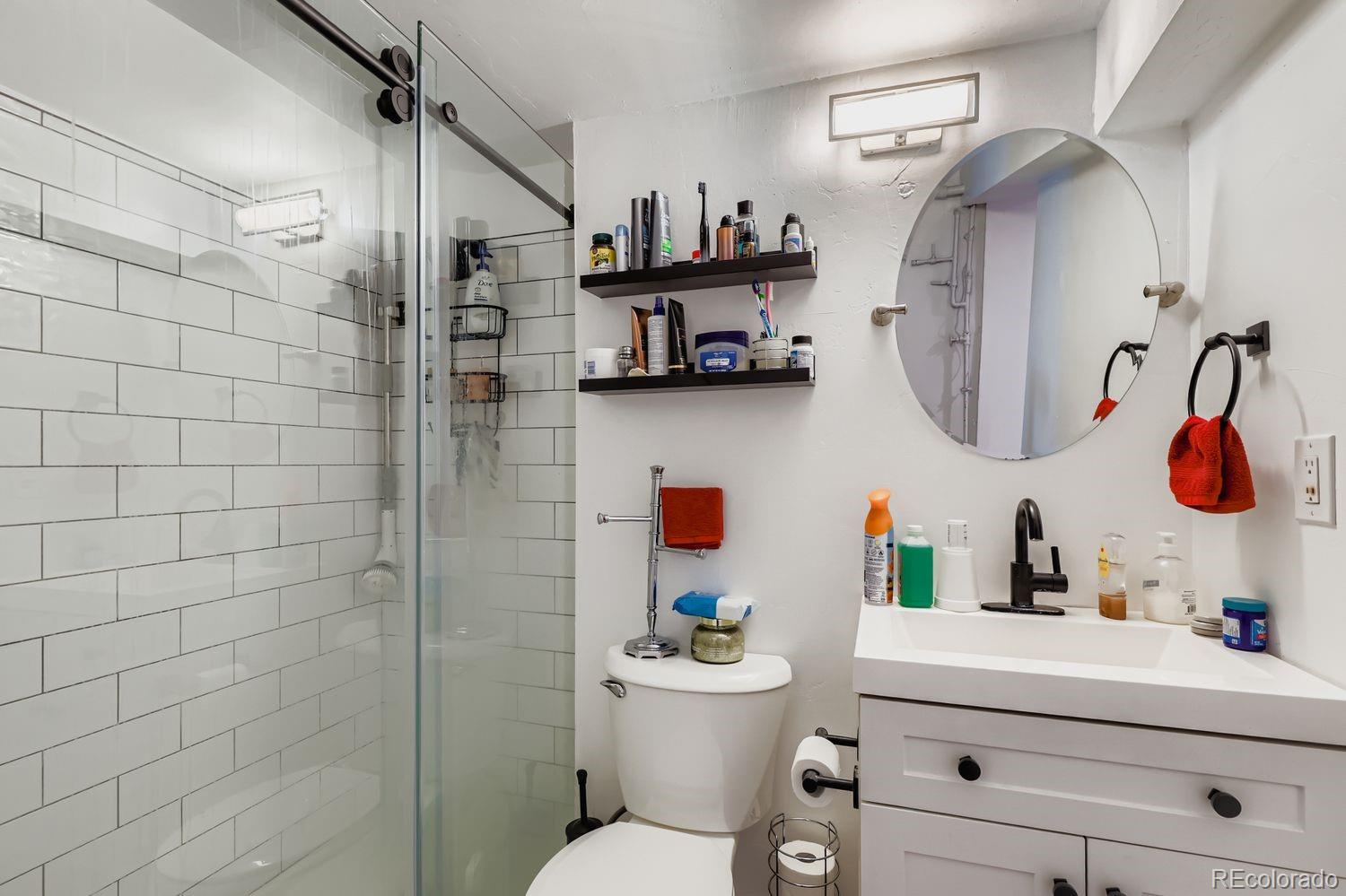854 North Clarkson Street Denver, CO 80218 - Photo 27 of 34 a bathroom with a sink mirror toilet and vanity