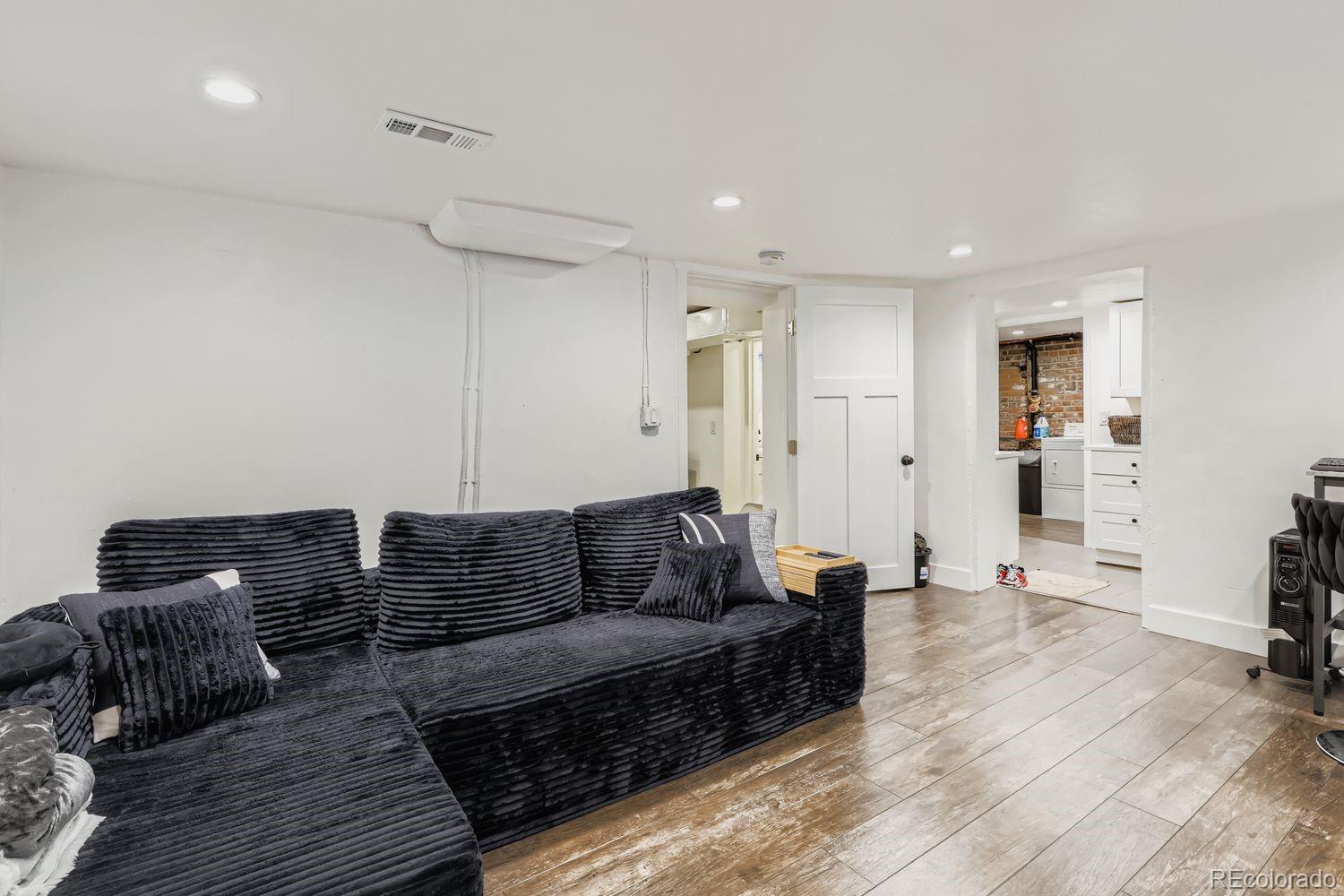 854 North Clarkson Street Denver, CO 80218 - Photo 29 of 34 a living room with furniture and wooden floor