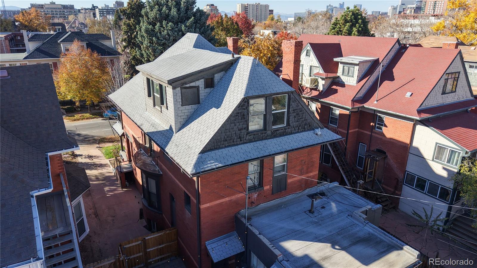854 North Clarkson Street Denver, CO 80218 - Photo 31 of 34 a view of a patio with table and chairs a barbeque with wooden floor and fence
