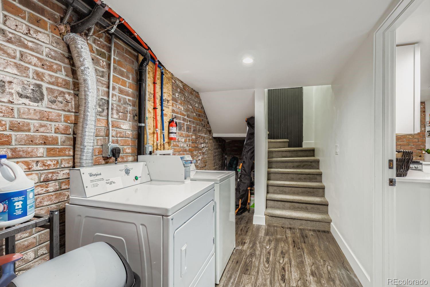 854 North Clarkson Street Denver, CO 80218 - Photo 6 of 34 a view of washer and dryer with kitchen view