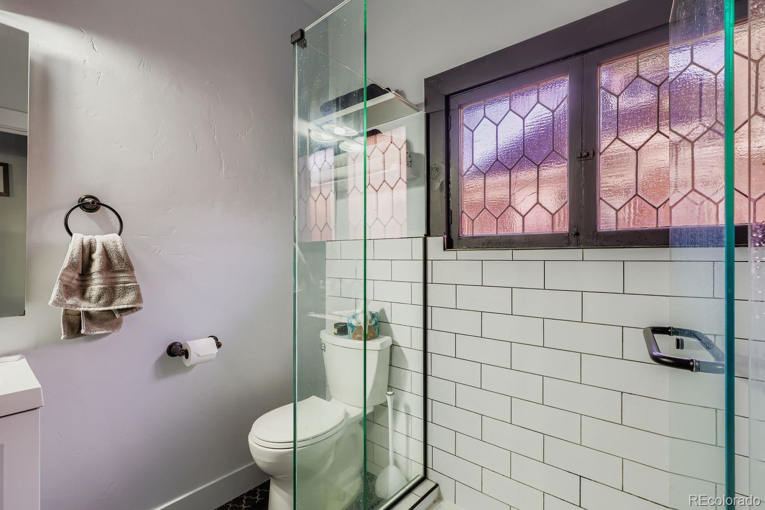 854 North Clarkson Street Denver, CO 80218 - Photo 8 of 34 a bathroom with a toilet sink and mirror