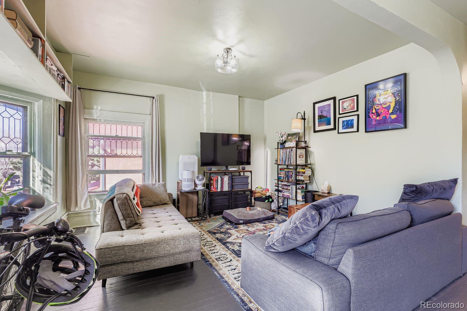854 North Clarkson Street Denver, CO 80218 - Photo 10 of 34 a living room with furniture a flat screen tv and a large window