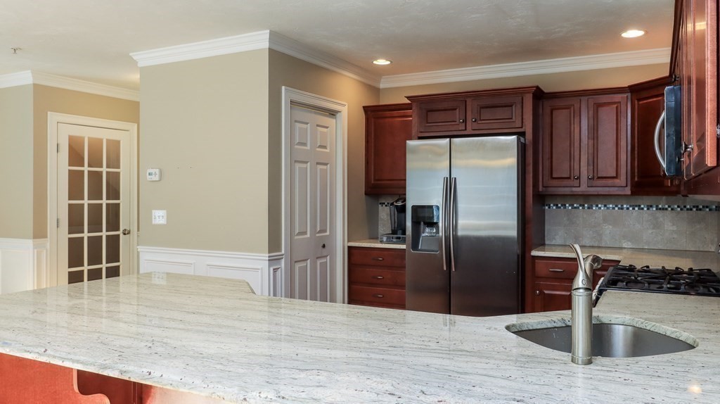 85 Dudley Road, Unit 85 Berlin, MA 01503 - Photo 12 of 39 a kitchen with stainless steel appliances granite countertop a refrigerator and a sink