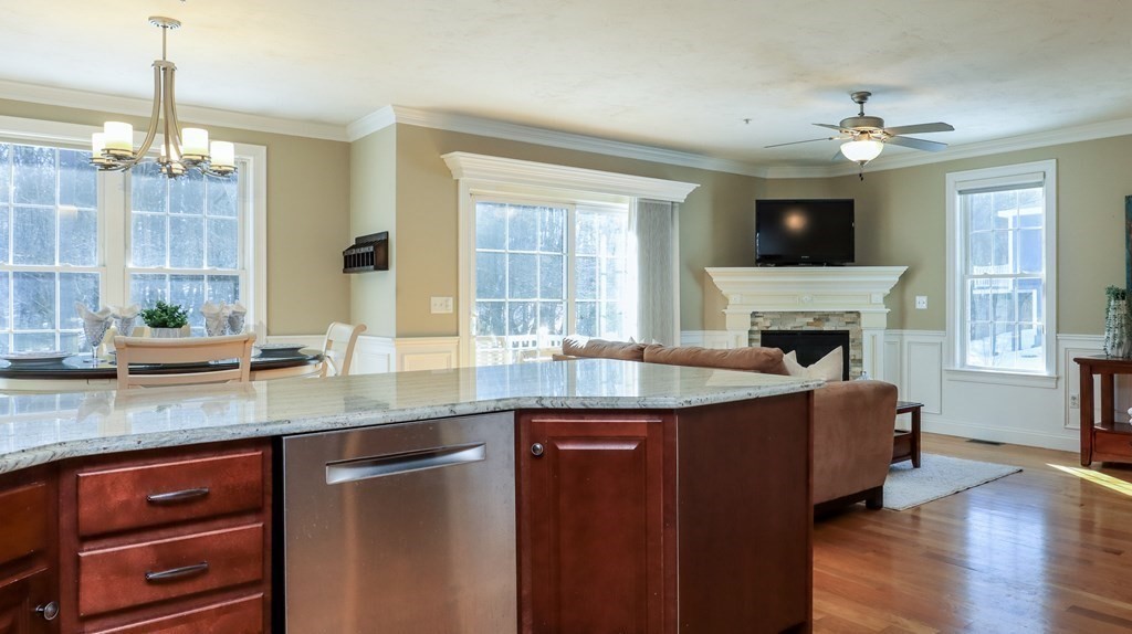 85 Dudley Road, Unit 85 Berlin, MA 01503 - Photo 13 of 39 a living room with granite countertop furniture fireplace and flat screen tv