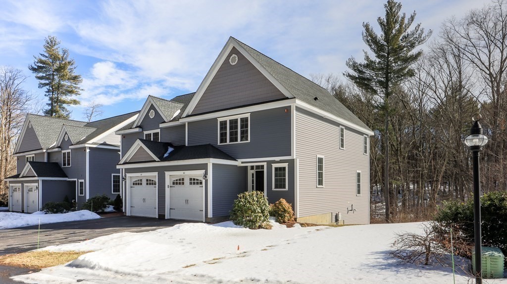 85 Dudley Road, Unit 85 Berlin, MA 01503 - Photo 3 of 39 a front view of a house with a yard