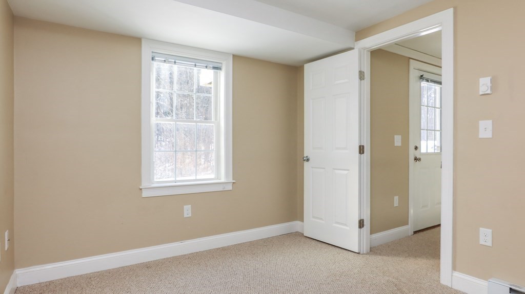 85 Dudley Road, Unit 85 Berlin, MA 01503 - Photo 31 of 39 an empty room with windows and closet