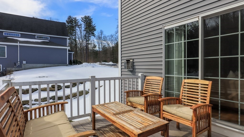 85 Dudley Road, Unit 85 Berlin, MA 01503 - Photo 32 of 39 a view of a chairs and table in the balcony