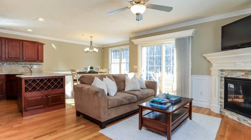 85 Dudley Road, Unit 85 Berlin, MA 01503 - Photo 6 of 39 a living room with furniture fireplace and a flat screen tv