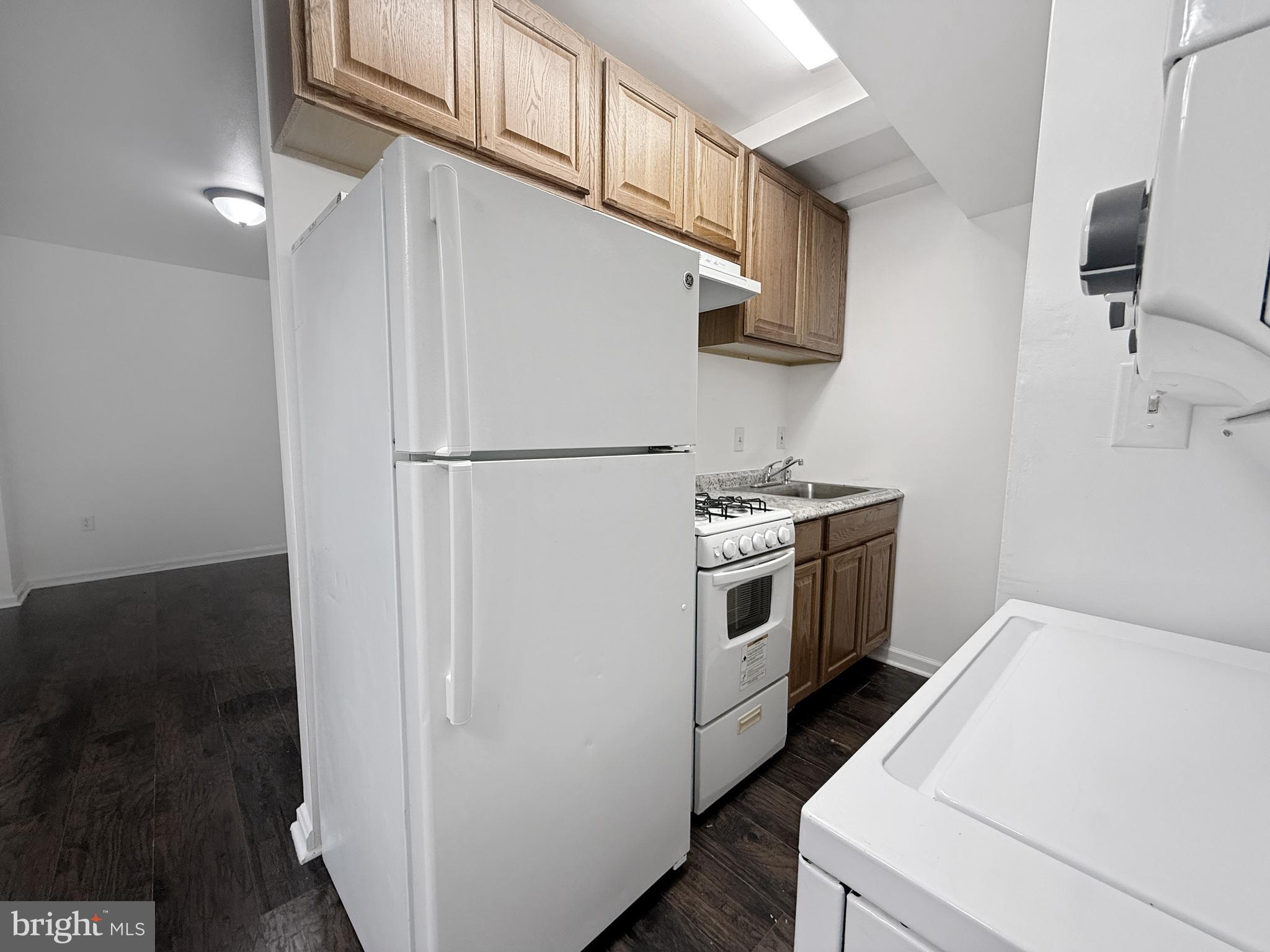 506 Eastern Avenue Northeast, Unit 102 Washington, DC 20019 - Photo 1 of 13 a white refrigerator freezer and a stove sitting inside of a kitchen