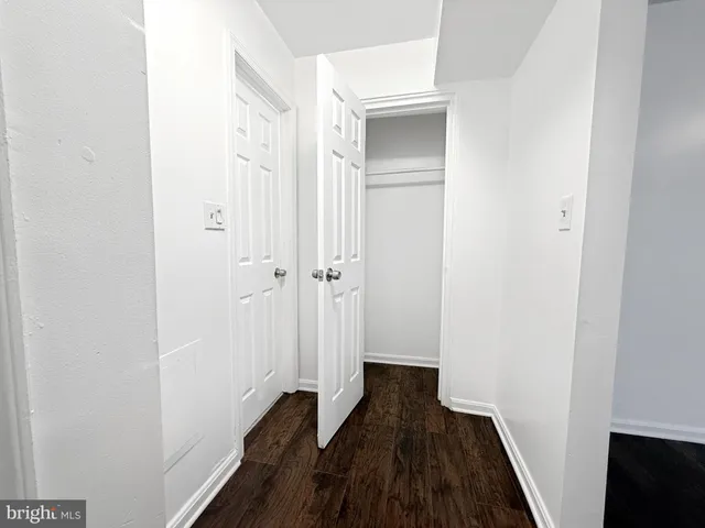 a view of a room with wooden floor