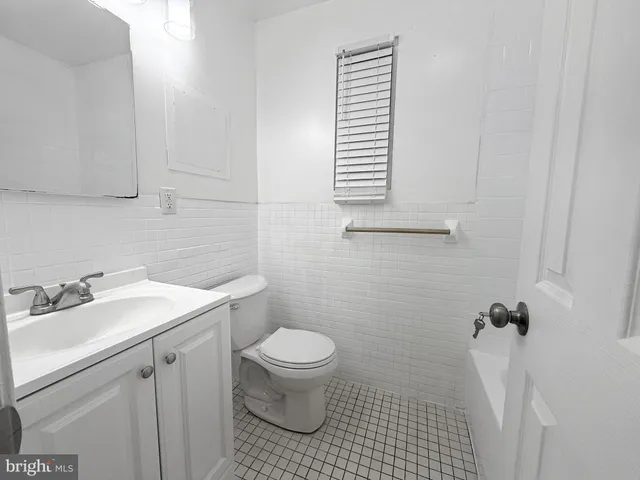 a bathroom with a sink toilet and window