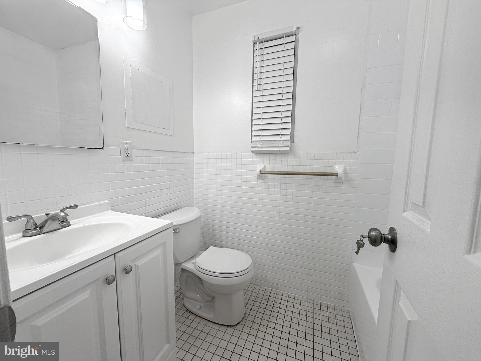 506 Eastern Avenue Northeast, Unit 102 Washington, DC 20019 - Photo 3 of 13 a bathroom with a sink toilet and window