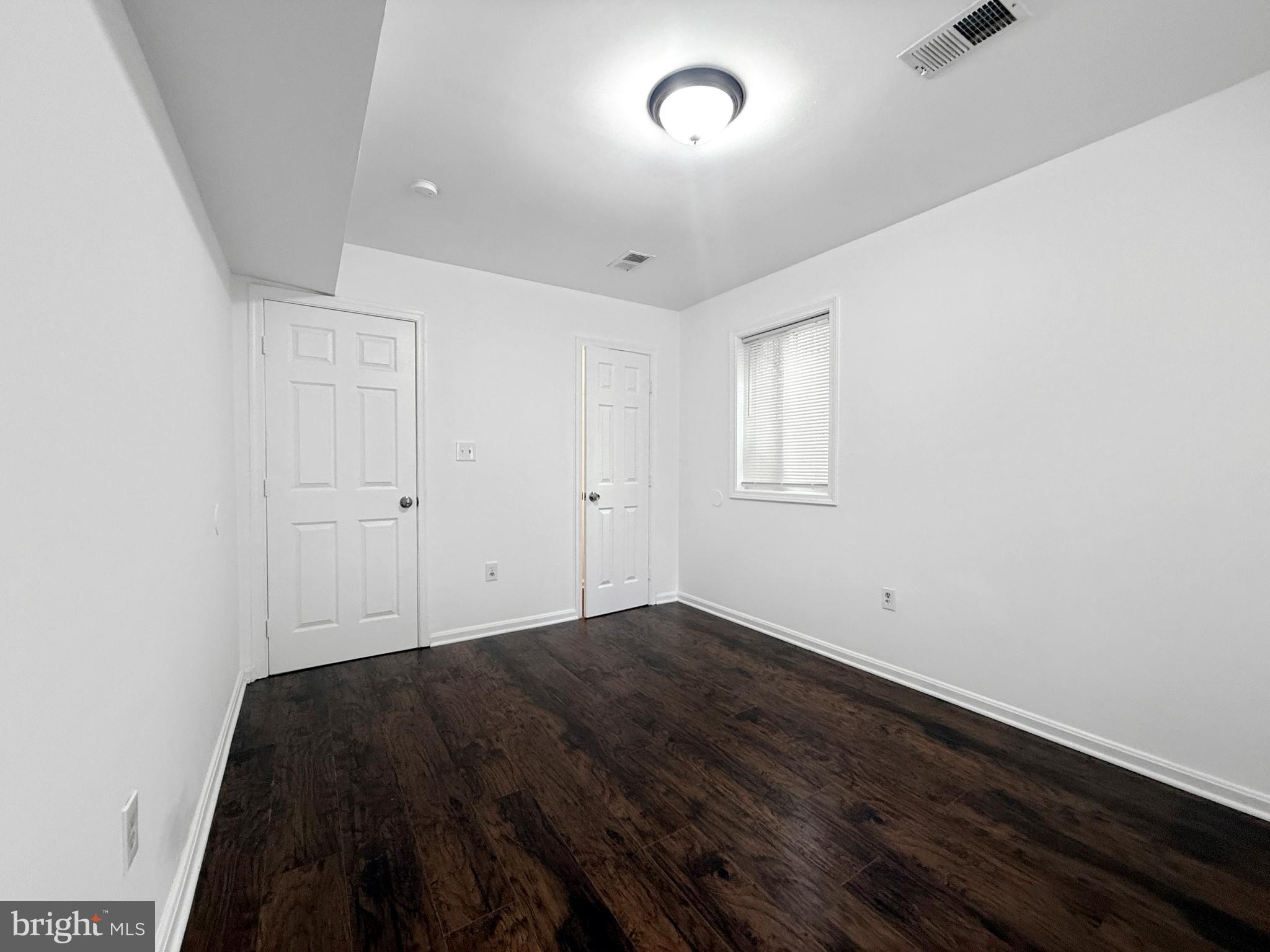 506 Eastern Avenue Northeast, Unit 102 Washington, DC 20019 - Photo 4 of 13 an empty room with wooden floor