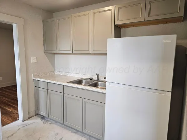 a white refrigerator freezer sitting inside of a kitchen