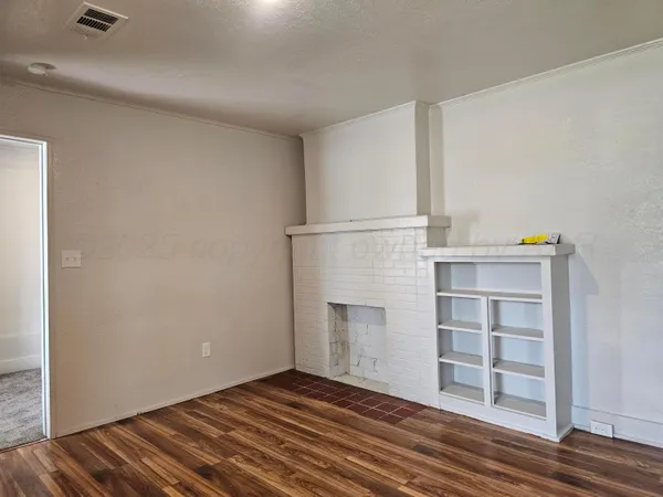 a view of a room with wooden floor