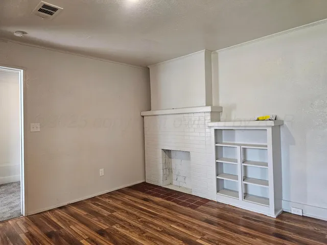 a view of a room with wooden floor