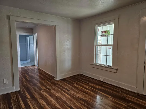 a view of a room with wooden floor
