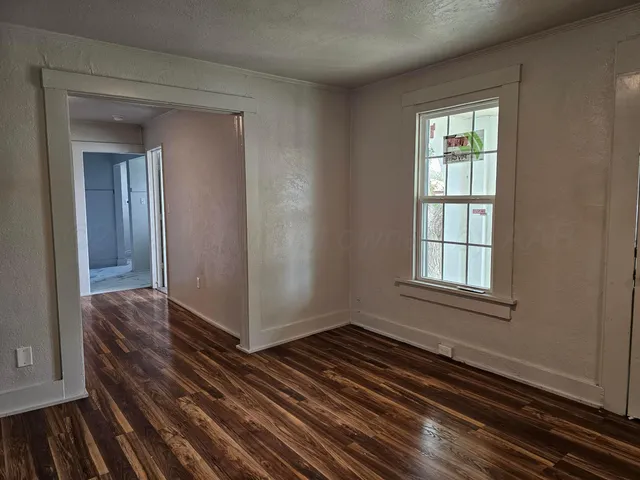 a view of a room with wooden floor