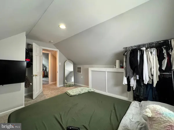 a bed room with a bed and a flat tv screen